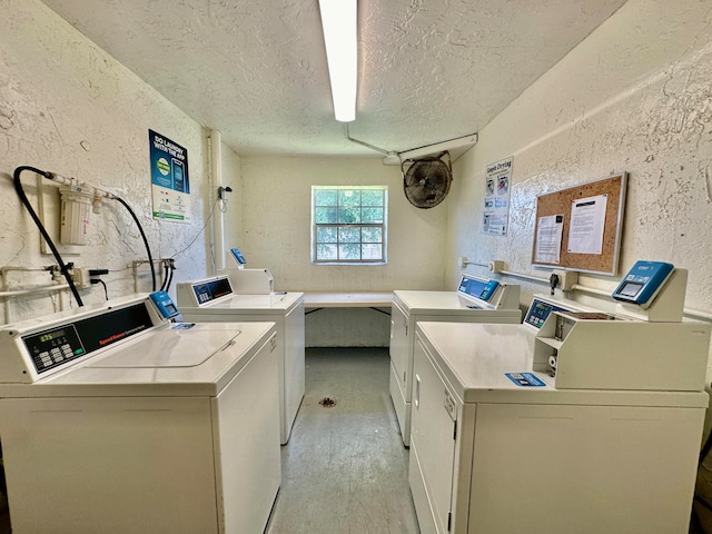 washroom with light hardwood / wood-style flooring, a textured ceiling, and washer and dryer