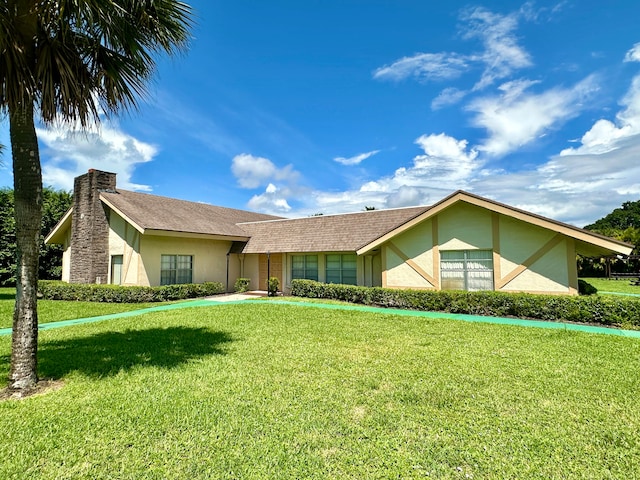 ranch-style house with a front lawn