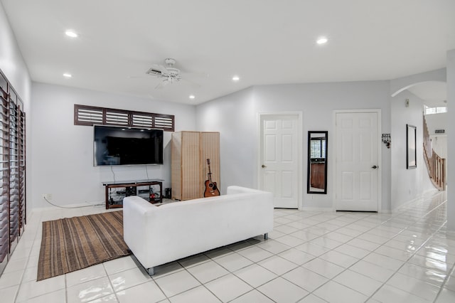 living room with light tile patterned floors and ceiling fan