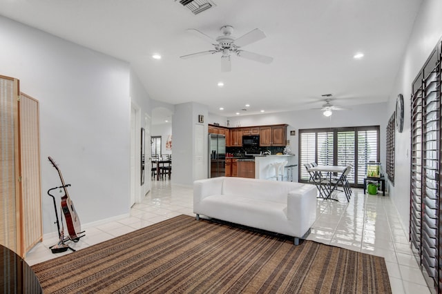 living room featuring ceiling fan and light tile patterned floors