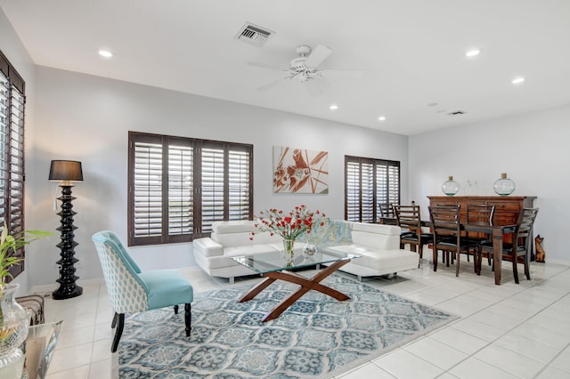 living room with ceiling fan, light tile patterned flooring, and a wealth of natural light