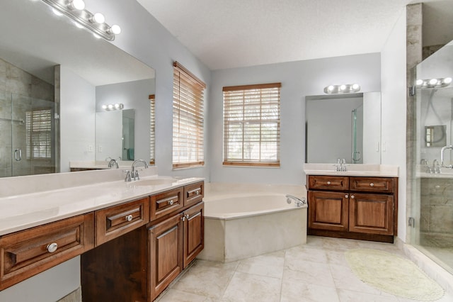 bathroom featuring vanity, plus walk in shower, a textured ceiling, and tile patterned floors