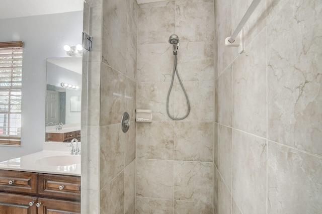 bathroom with vanity and tiled shower