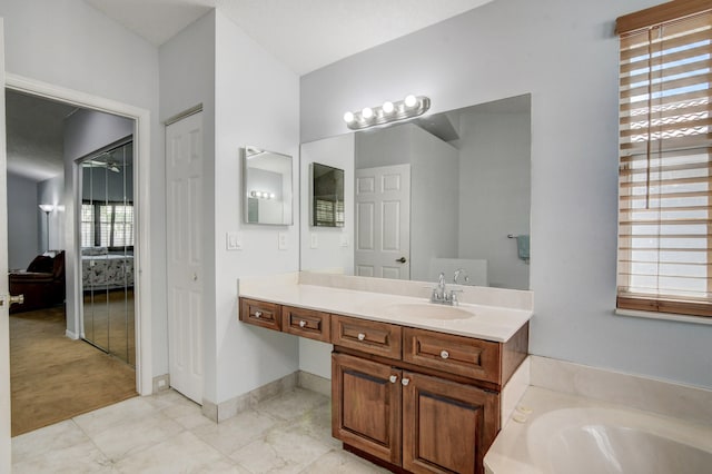 bathroom with vanity and a tub