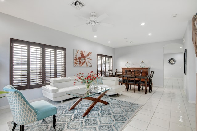 tiled living room featuring ceiling fan