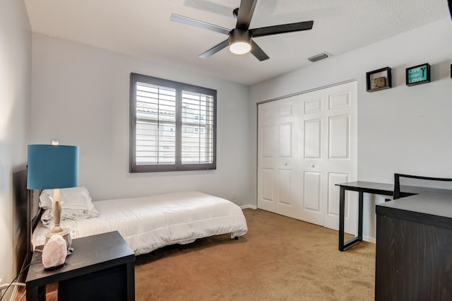 carpeted bedroom with a closet and ceiling fan