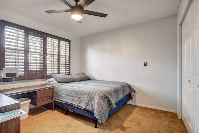 bedroom featuring light carpet, a closet, and ceiling fan