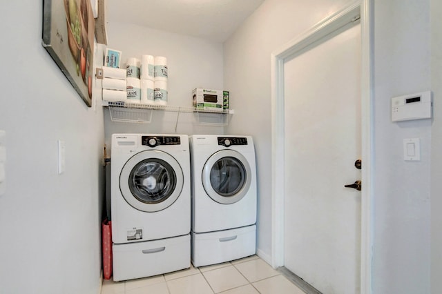 laundry area featuring independent washer and dryer and light tile patterned flooring