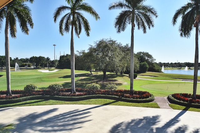 surrounding community with a yard and a water view