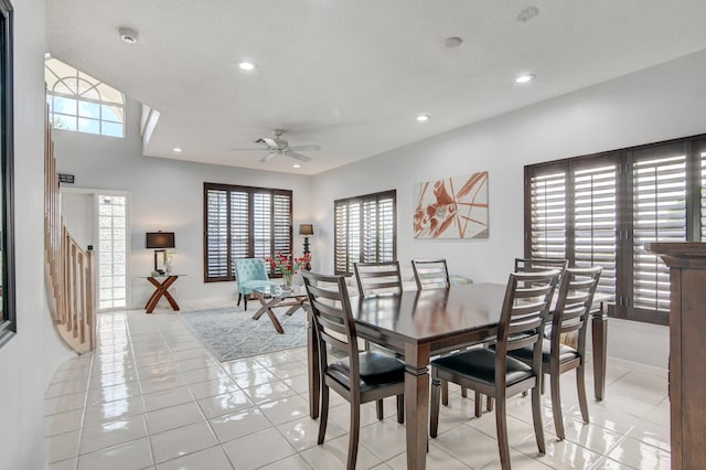 tiled dining space with ceiling fan and a textured ceiling