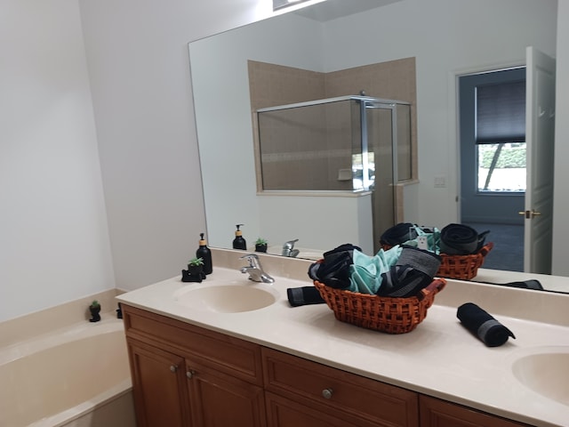 bathroom featuring shower with separate bathtub and vanity