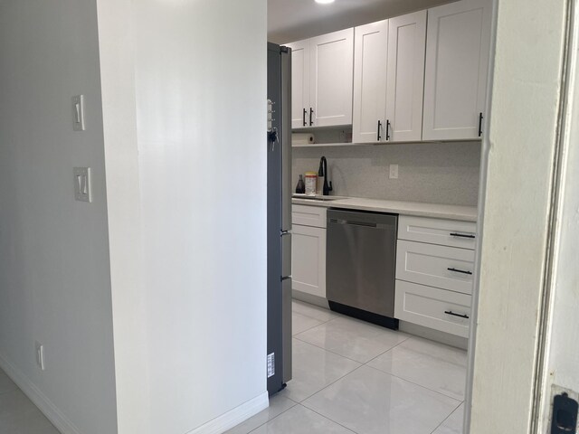 kitchen featuring white cabinets, light tile patterned flooring, and appliances with stainless steel finishes