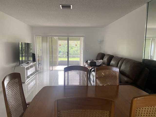 dining room featuring a textured ceiling