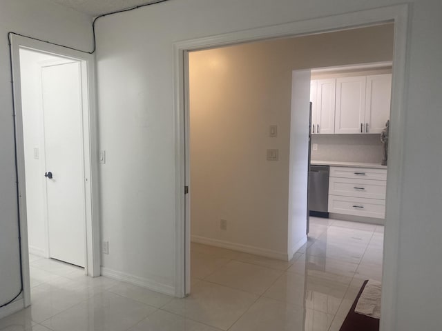 corridor featuring light tile patterned floors