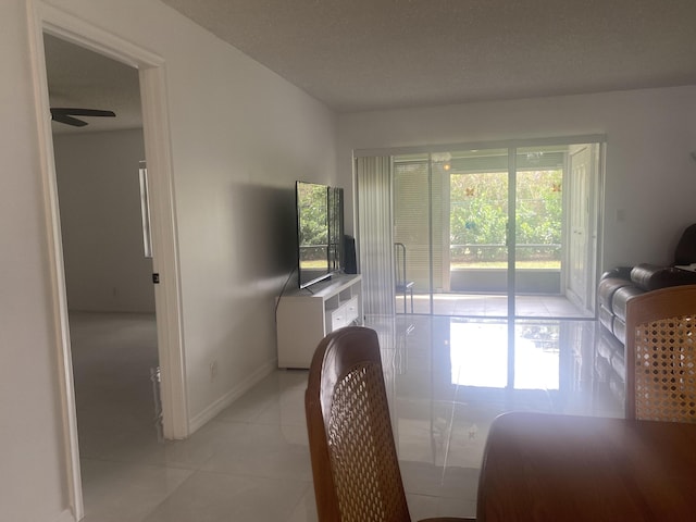 dining area featuring light tile patterned floors and ceiling fan