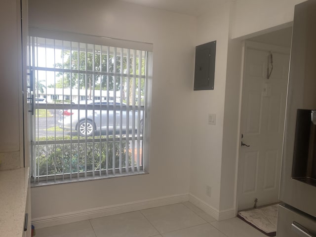 interior space with electric panel, a healthy amount of sunlight, and light tile patterned flooring