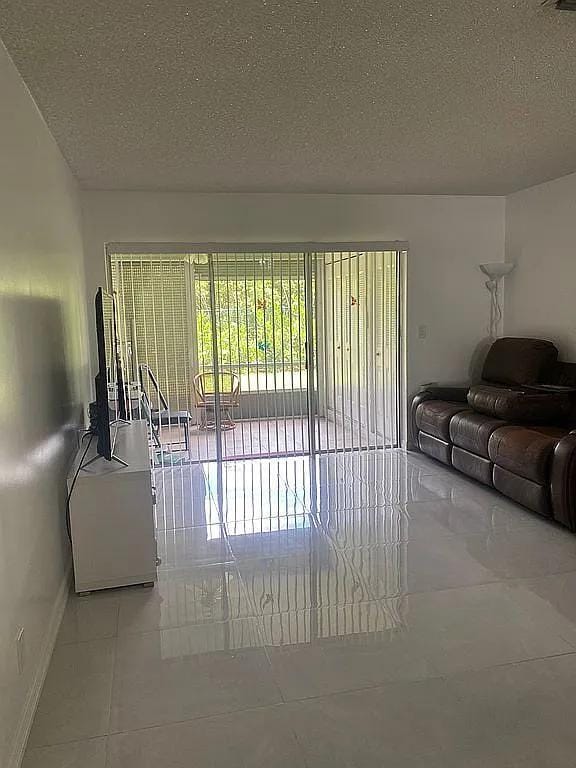 living room with light tile patterned floors and a textured ceiling