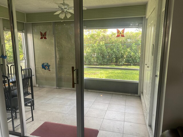 entryway with ceiling fan and light tile patterned floors