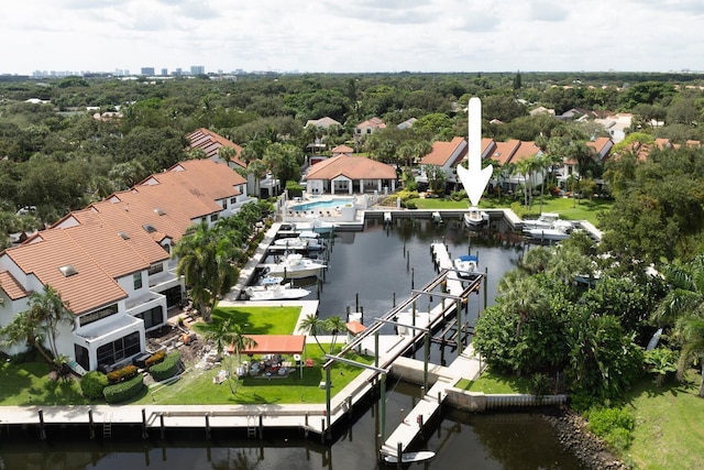 drone / aerial view featuring a water view and a residential view