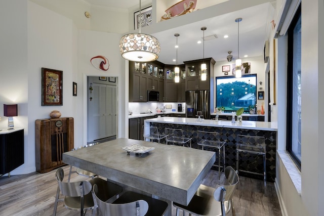 dining room with crown molding and light hardwood / wood-style floors