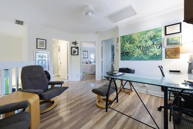 office area with wood-type flooring and crown molding