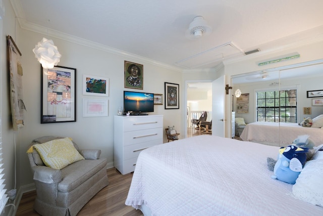 bedroom with wood-type flooring and crown molding