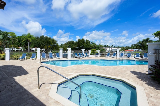 view of pool with a community hot tub and a patio