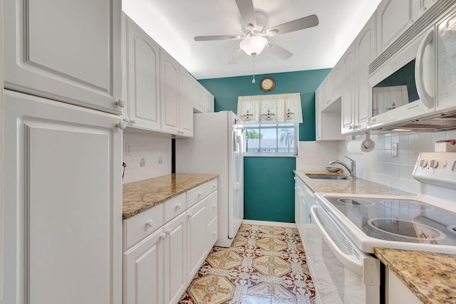 kitchen featuring ceiling fan, sink, tasteful backsplash, white appliances, and white cabinetry