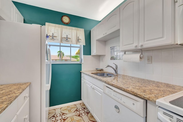 kitchen featuring decorative backsplash, white cabinetry, white appliances, light tile patterned floors, and sink