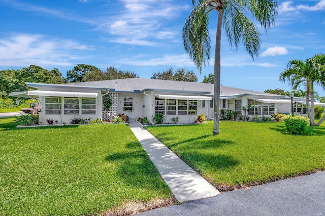 ranch-style home featuring a front yard