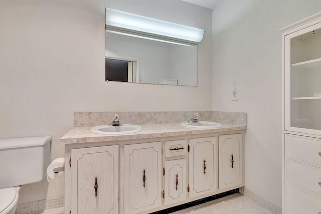 bathroom featuring tile patterned floors, vanity, and toilet