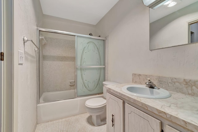 full bathroom featuring tile patterned flooring, toilet, vanity, and combined bath / shower with glass door