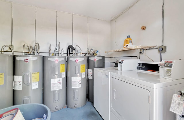 laundry room with water heater and separate washer and dryer