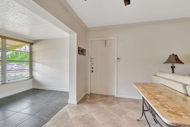 tiled foyer featuring crown molding