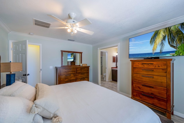 bedroom with ceiling fan, ensuite bath, and crown molding