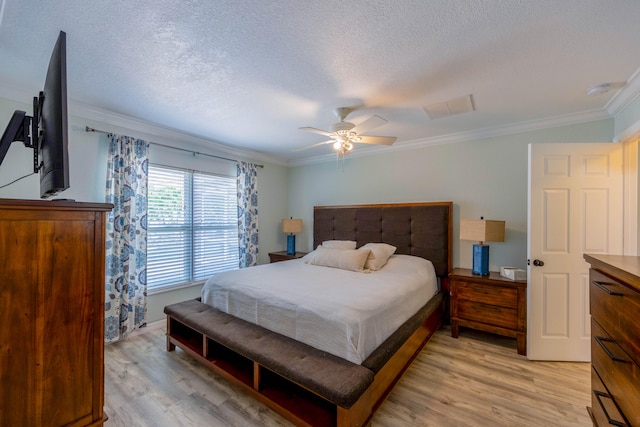 bedroom featuring ceiling fan, ornamental molding, a textured ceiling, and light hardwood / wood-style floors