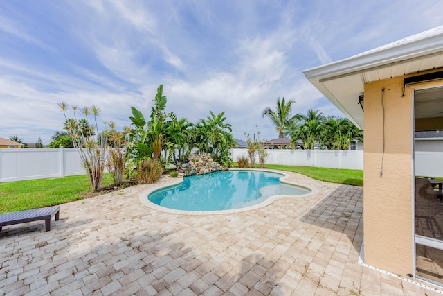 view of swimming pool featuring a lawn and a patio area