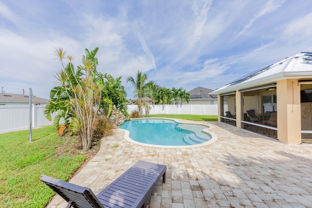 view of pool featuring a yard and a patio