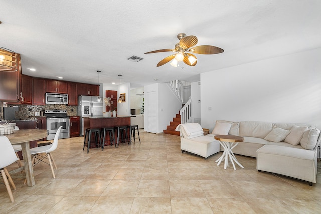 living room with ceiling fan and light tile patterned floors