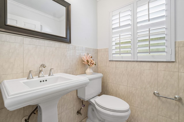 bathroom with tile walls, toilet, and sink