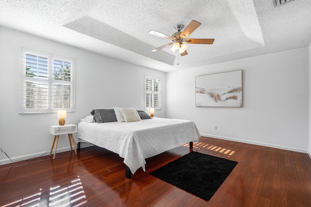 bedroom featuring wood-type flooring, a textured ceiling, and ceiling fan