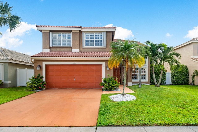 mediterranean / spanish home with a garage and a front lawn