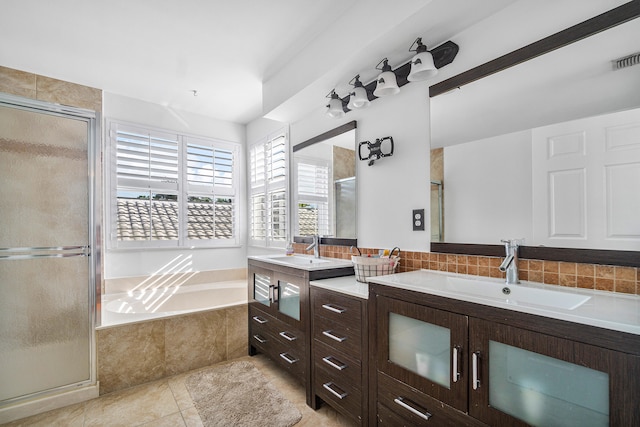 bathroom with tile patterned flooring, vanity, and plus walk in shower