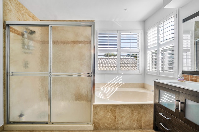 bathroom with vanity and separate shower and tub