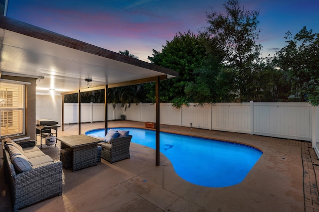 pool at dusk featuring a patio area