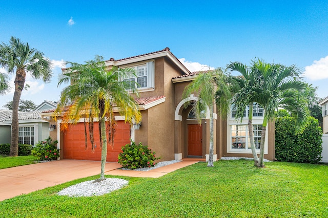 mediterranean / spanish house with a garage and a front yard