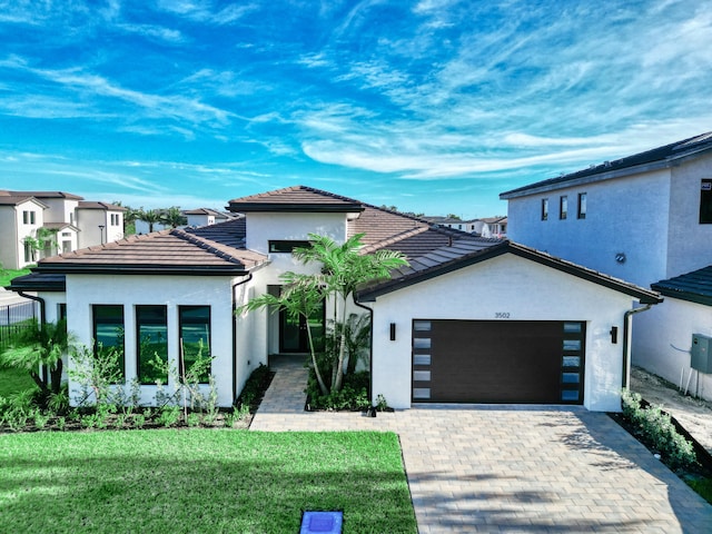 view of front facade with a garage and a front lawn