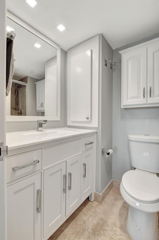 bathroom featuring walk in shower, vanity, and toilet