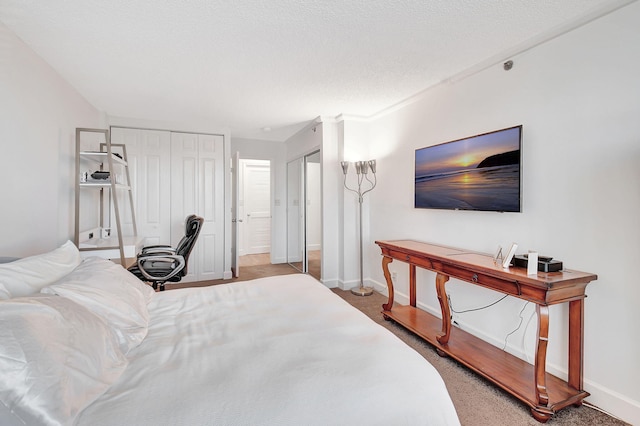 carpeted bedroom with a textured ceiling