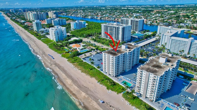 birds eye view of property with a view of the beach and a water view